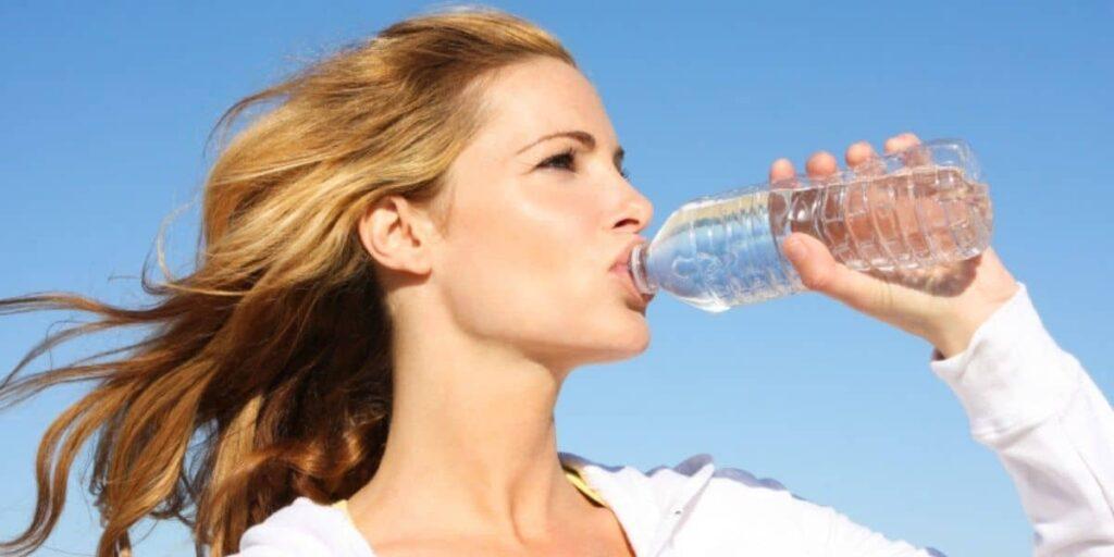 Women Drinking Water to help kidney stones pass