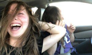 Family laughing in the car, totally cracking up, relieving stress
